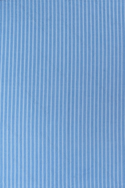 Dark blue organic cotton shirting fabric with clean white yarn-dyed stripe pattern, folded to highlight texture and weave.