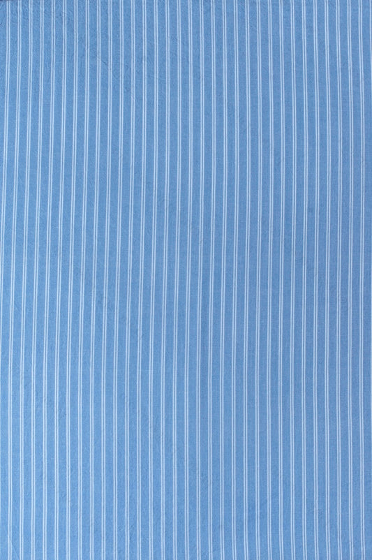 Dark blue organic cotton shirting fabric with clean white yarn-dyed stripe pattern, folded to highlight texture and weave.