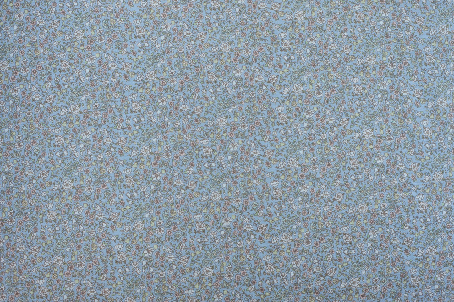 Organic cotton fabric with dense floral print on pale blue background featuring vintage-inspired botanical pattern.
