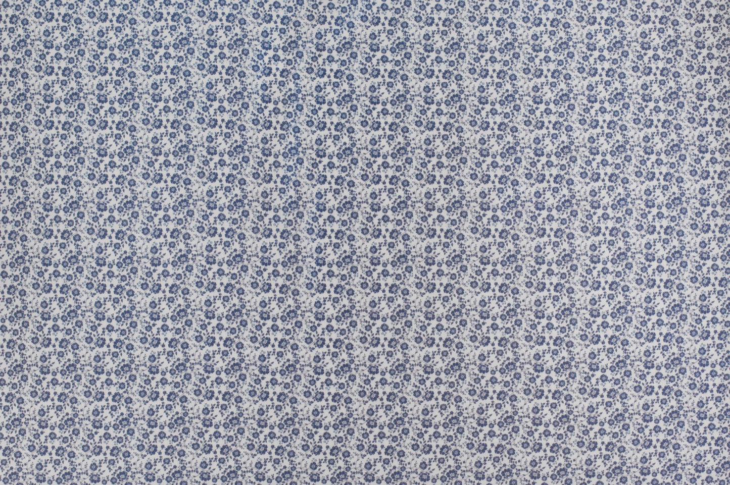 Organic cotton fabric with delicate blue ditsy floral print on ivory background, vintage inspired lightweight sewing fabric.