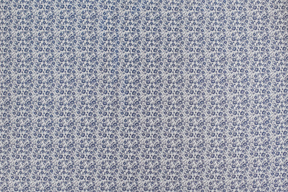 Organic cotton fabric with delicate blue ditsy floral print on ivory background, vintage inspired lightweight sewing fabric.