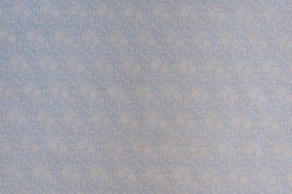Organic cotton cambric fabric featuring delicate powder blue cabbage rose floral vine print on soft ivory background.